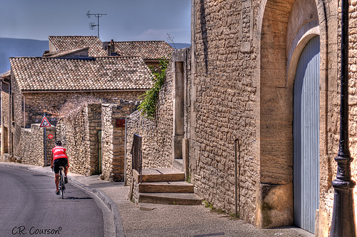 Cyclist in Gordes by C.R. Courson